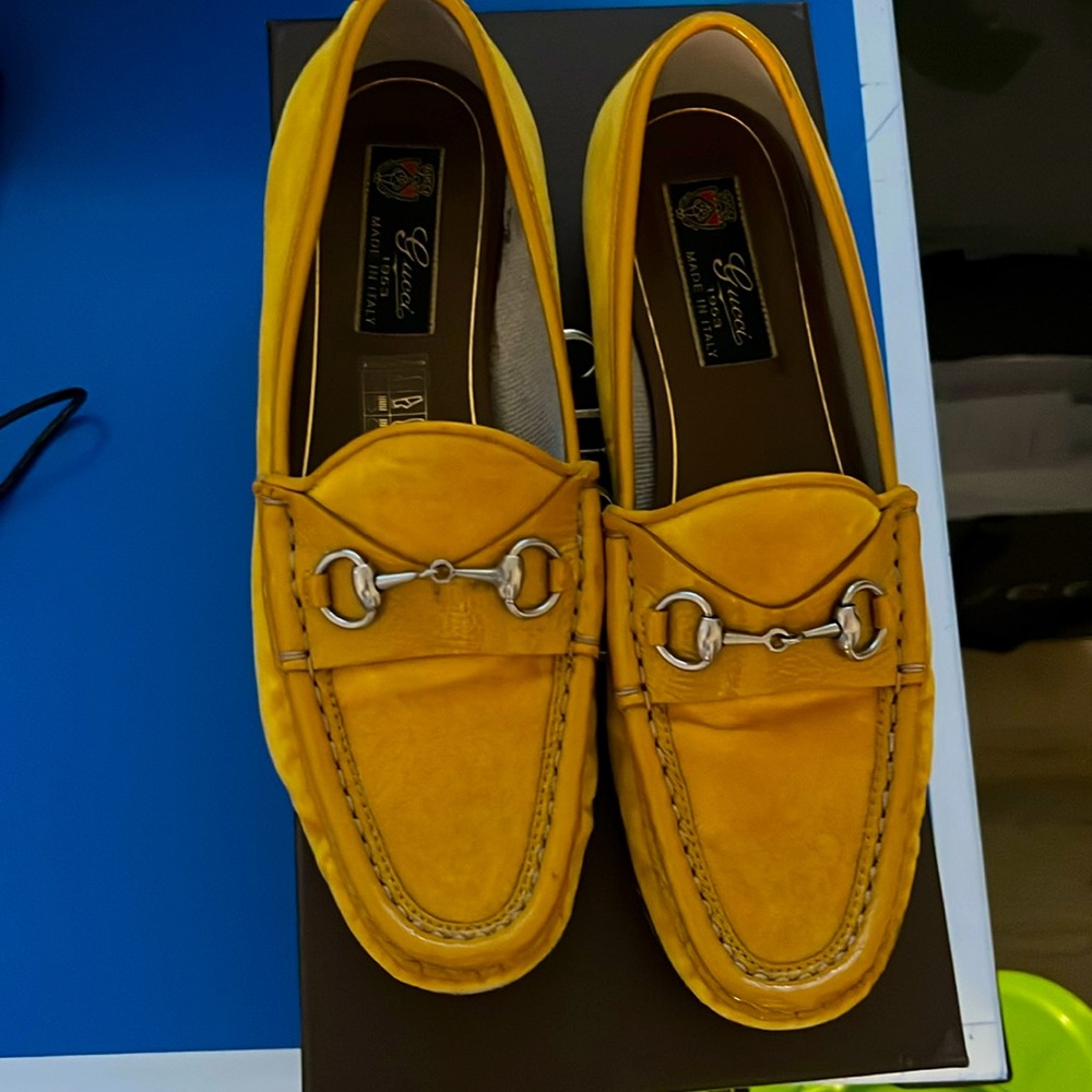 Yellow gold loafers with silver colored horsebit.